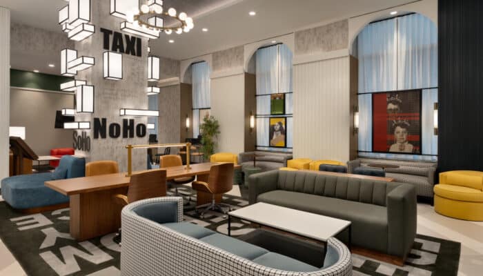 Interior hotel lobby with upholstered seating and chandelier